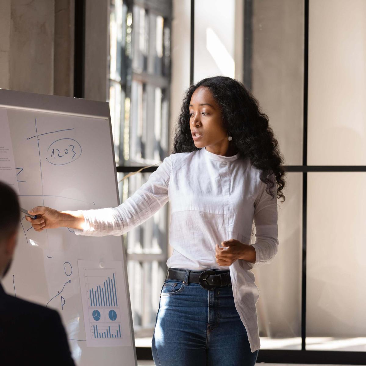 Two entrepreneurs collaborating at a desk with laptops and coffee